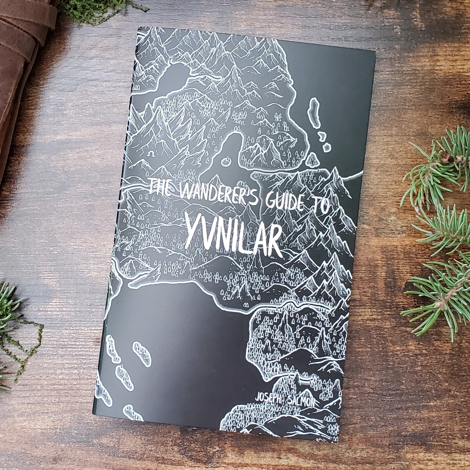 A black and white map covers the front of a zine titled "The Wanderer's Guide to Yvnilar", by Joseph Salmon